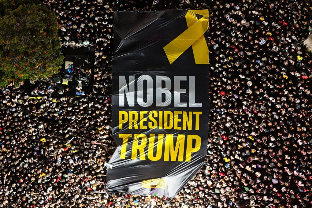 People hold up a giant sign with the words “NOBEL PRESIDENT TRUMP” as they gather in Tel Aviv, Israel, on Saturday. Photo: Reuters