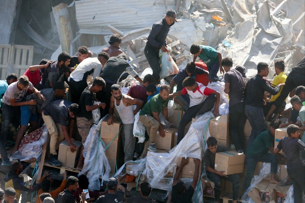 Palestinians collect aid supplies from a truck that entered Gaza on Sunday. Photo: Reuters