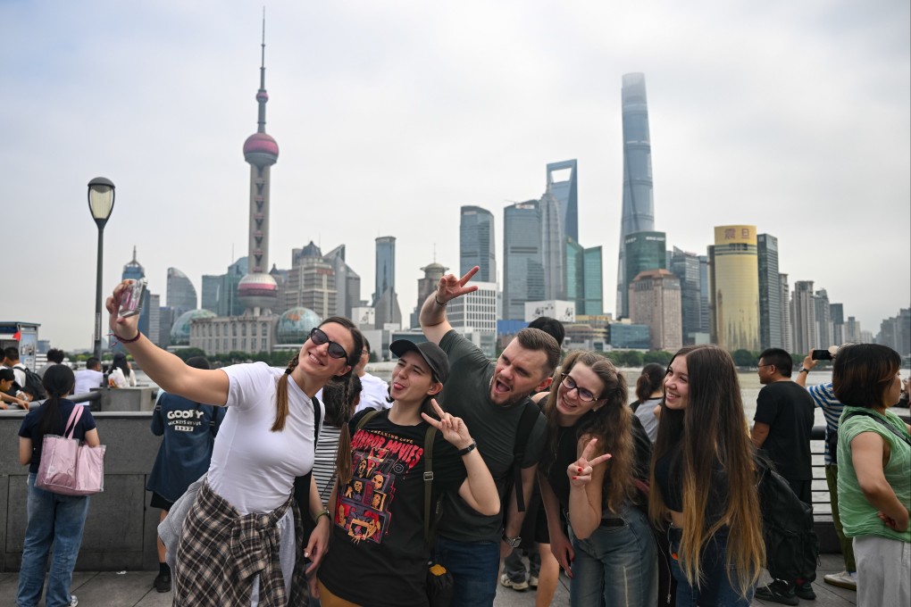 Tourists take selfies on the Bund in Shanghai on October 4, 2025. Photo: Xinhua