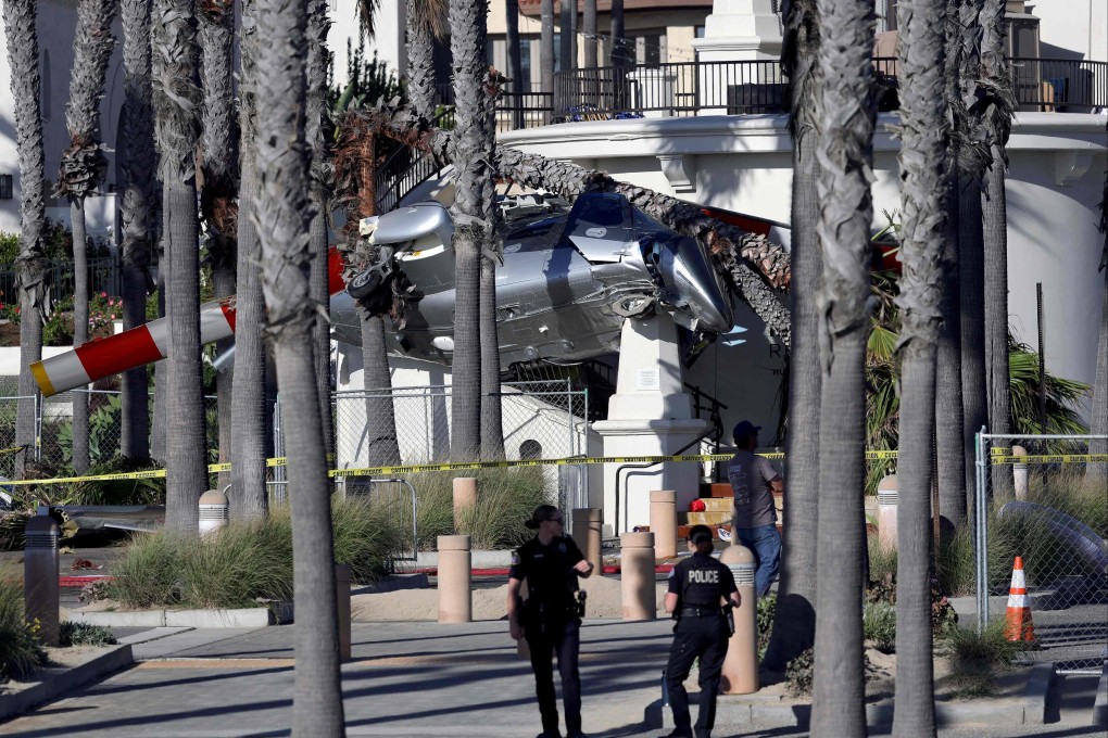 Police stand guard in front of a helicopter that crashed in Southern California on Saturday. Photo: Getty Images via AFP