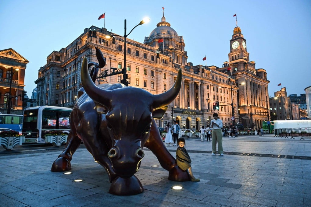 A child sits on a bull sculpture in Shanghai on April 9, 2025. Photo: AFP
