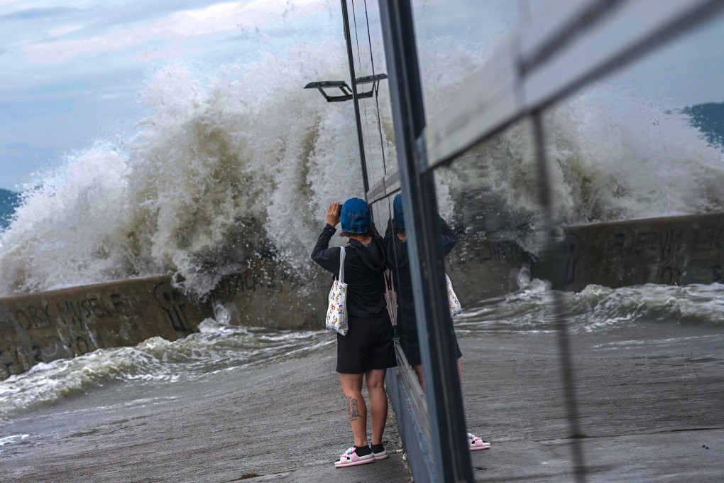 A resident snaps photos of powerful waves crashing into the Siu Sai Wan waterfront as Super Typhoon Ragasa approaches the city on September 23. Photo: Karma Lo