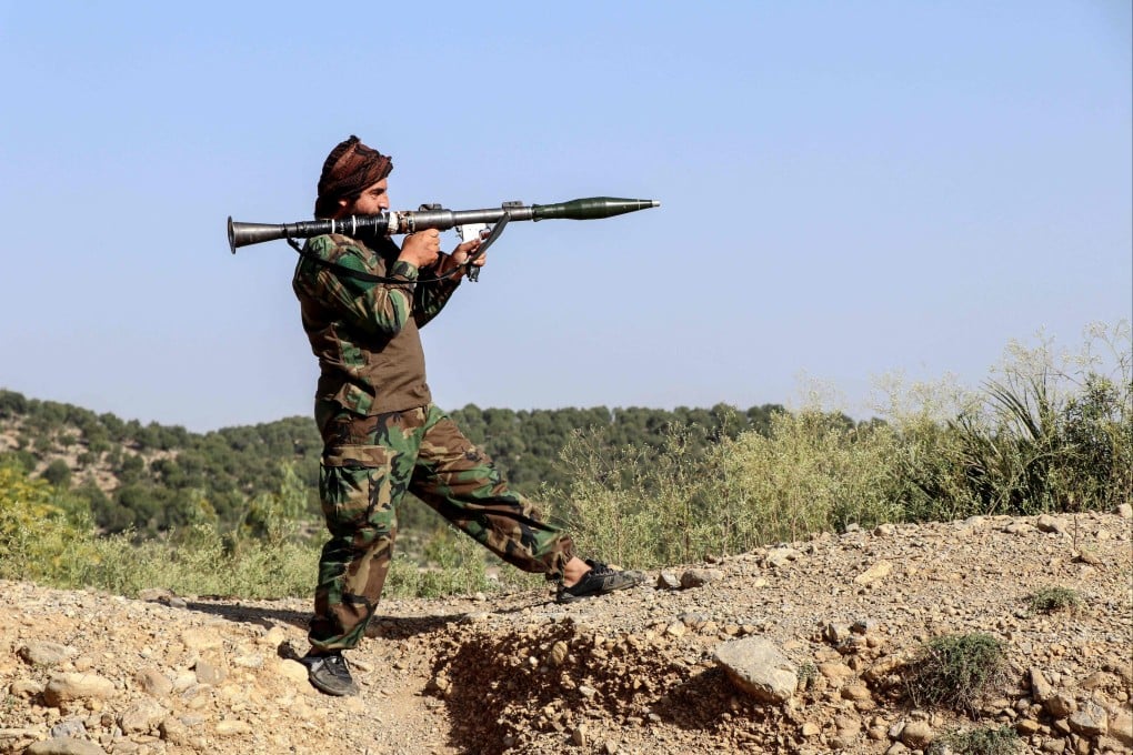 A Taliban security official holds a rocket-propelled grenade as he stands guard near the Afghanistan-Pakistan border on Sunday. Photo: AFP