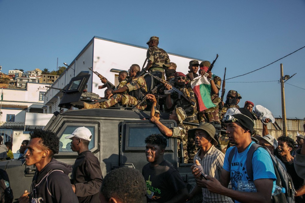 Members of a Madagascar army contingent known as Capsat interact with anti-government protesters in the capital city Antananarivo on Saturday. Photo: AFP