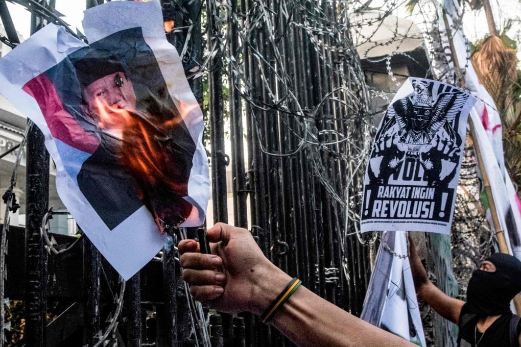 A demonstrator sets fire to a poster of Indonesia’s President Prabowo Subianto during a protest on September 1. Photo: AFP