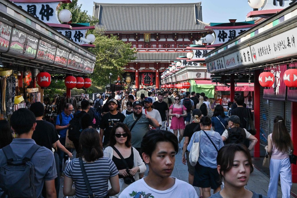 People walk past shops near Sensoji Temple in the Asakusa district of central Tokyo on September 16. Photo: AFP