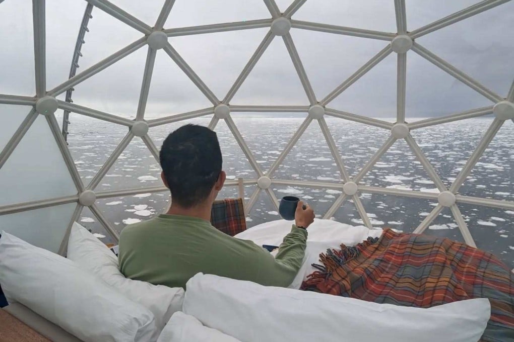 Travel blogger The Gastronomic Traveler from Taiwan enjoys a cup of coffee while looking out across Arctic waters from the glass igloo aboard the National Geographic Endurance cruise ship, operated by National Geographic-Lindblad Expeditions. Photo: Instagram/gastronomictraveler
