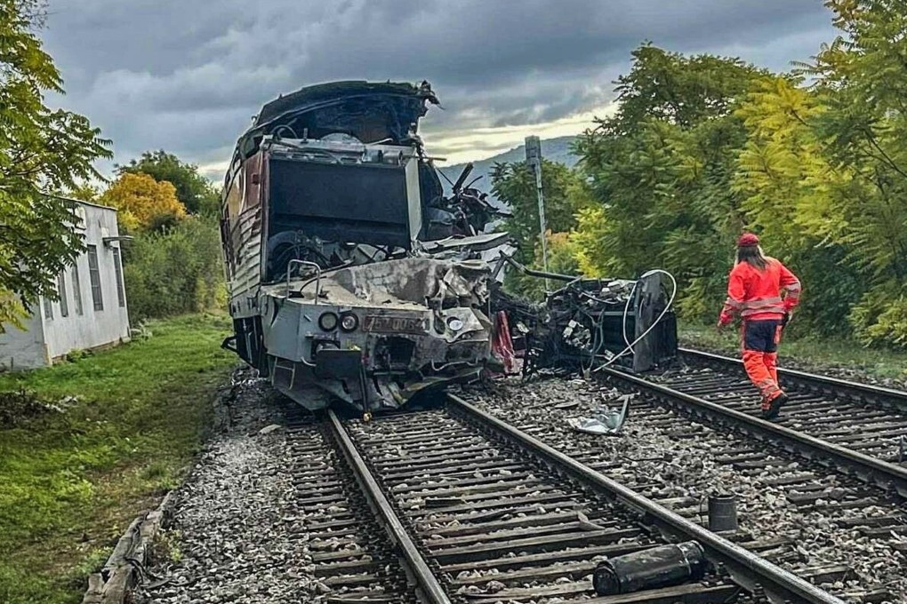 An emergency crew member is on the scene after two trains collided in Slovakia on Monday. Photo: Handout