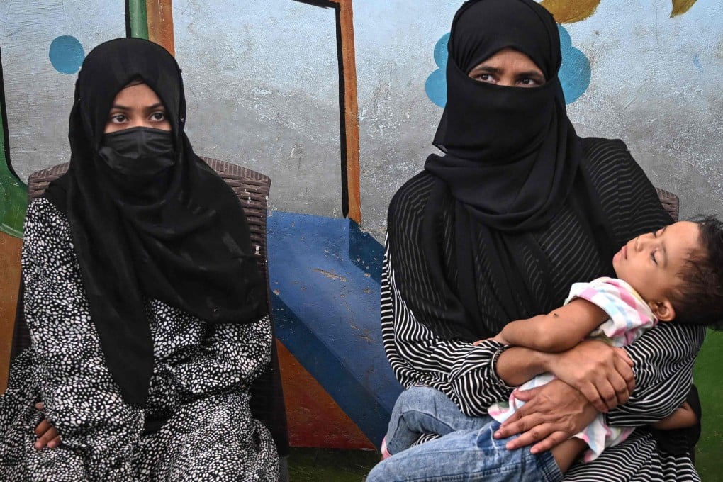 Amina (left), a household helper, sits beside her mother during an interview in Karachi. Photo: AFP