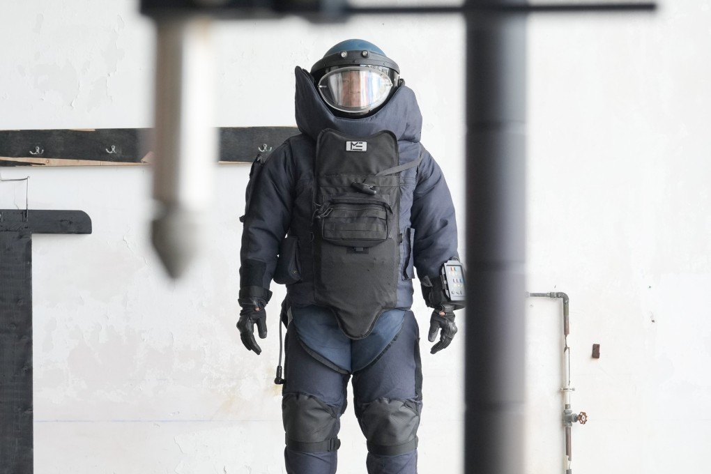 A member of police’s explosive ordnance disposal bureau wearing the protective gear used by officers during bomb disposal operations. Photo: May Tse
