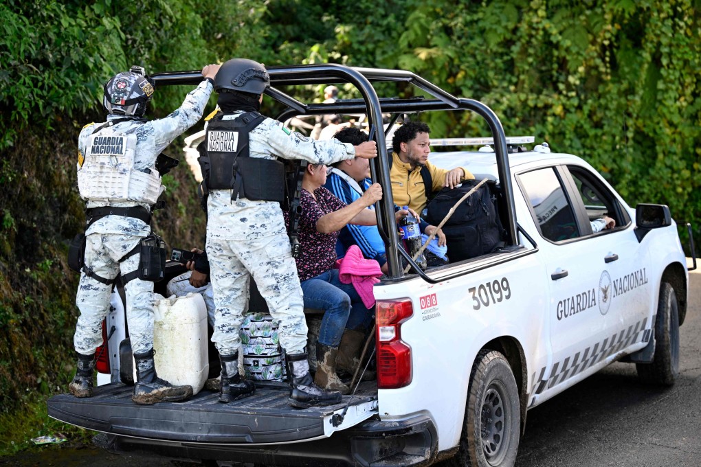 Members of the National Guard transport residents along the Tulancingo-Tenango road to Tulancingo after heavy rains in Hidalgo state, Mexico on Sunday. Photo: AFP