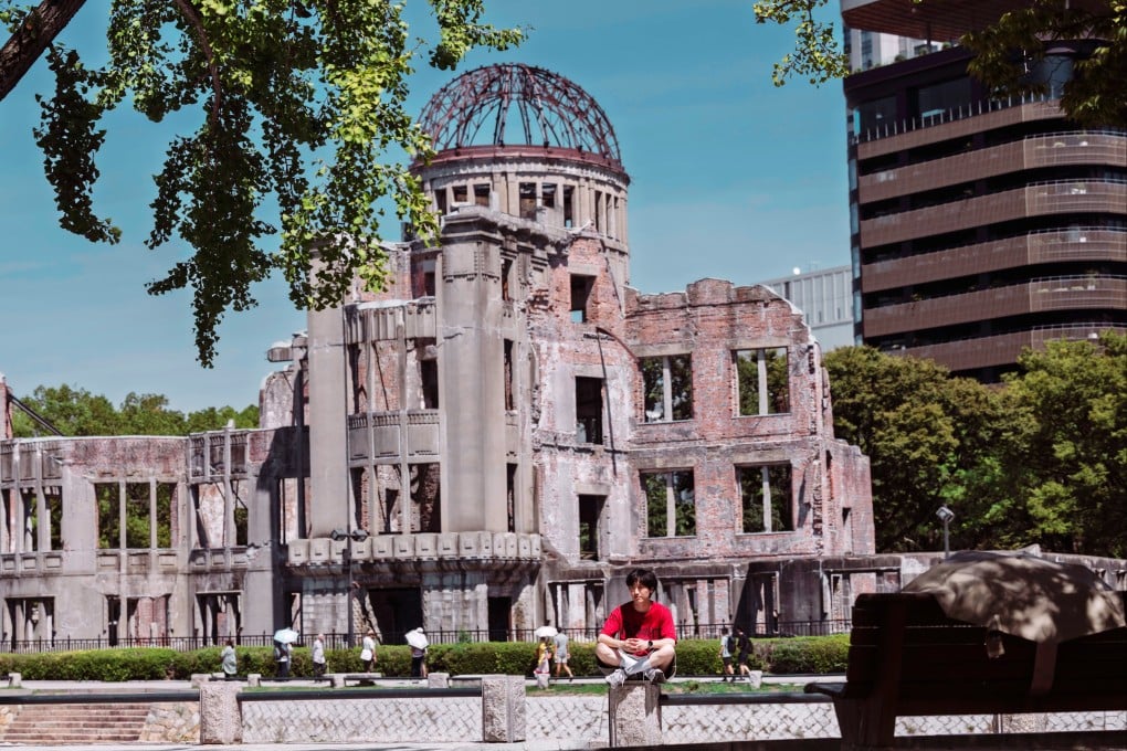 A person sits in front of the Atomic Bomb Dome memorial in Hiroshima, Japan, in September. Photo: EPA