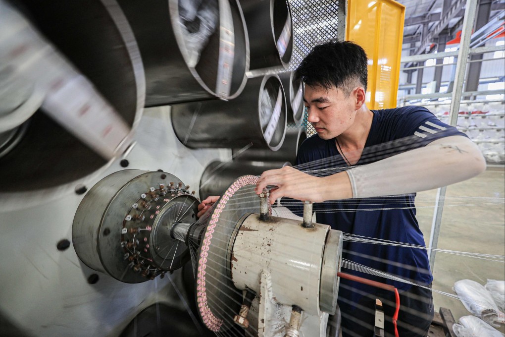 An employee works on a production line for tubular products for export at a factory in Lianyungang, Jiangsu province, on July 8. Photo: AFP