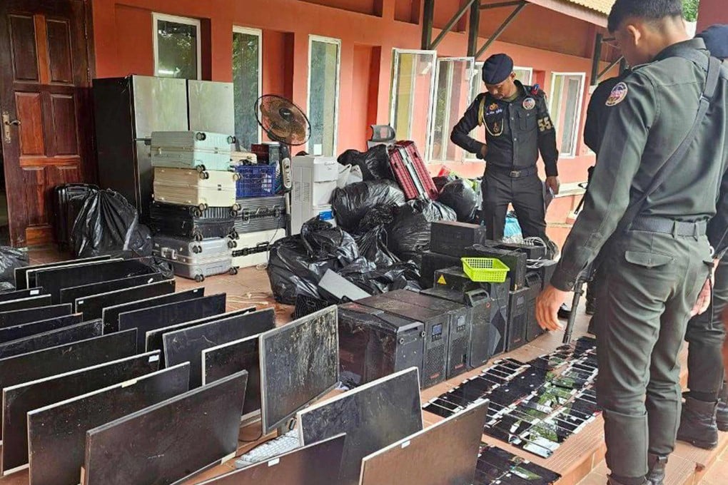Cambodian military police look over equipment seized during a raid on a scam centre in Kandal province on July 17. Photo: Agence Kampuchea Presse/AFP