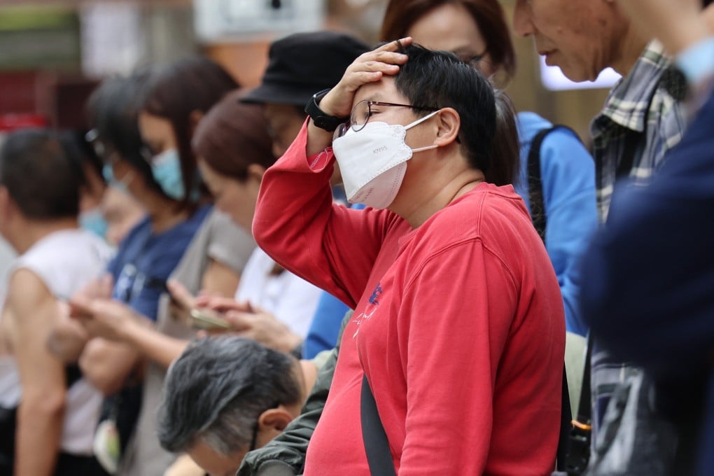 A woman wears a surgical mask at a bus stop in Mong Kok. Photo: Jelly Tse
