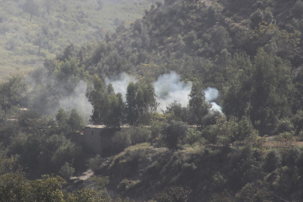 Smoke rises from a hillside following overnight clashes between Afghan and Pakistani forces along the border on Sunday. Photo: AP