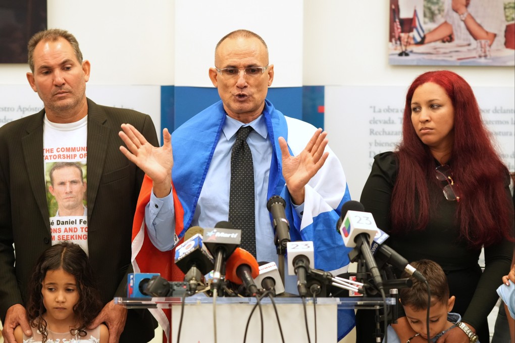 Cuban dissident Jose Daniel Ferrer, wearing his nation’s flag over his shoulders, gives a news conference in Miami, Florida on Monday, the day he left Cuba for exile in the US. Photo: AP