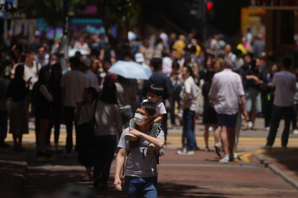 Pedestrians wearing face masks. An expert has said the number of flu cases has not yet peaked and that the summer season may last at least until November. Photo: Sam Tsang