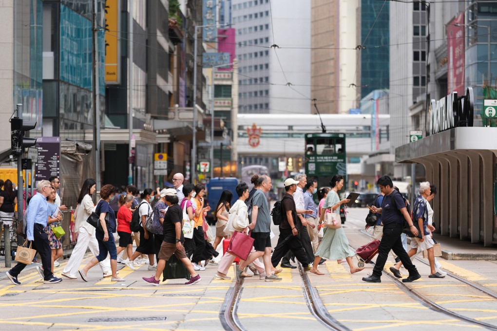 People cross a street in Central on September 16, 2025. Photo: Eugene Lee