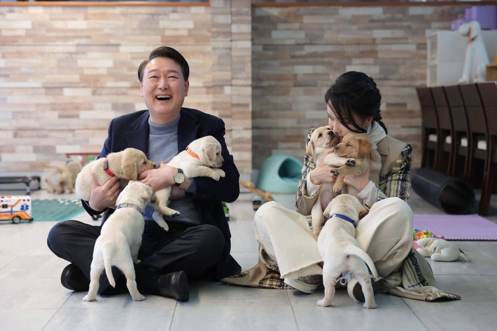 Former South Korean president Yoon Suk-yeol and his wife Kim Keon-hee posing with puppies in Yongin, South Korea. Photo: AFP