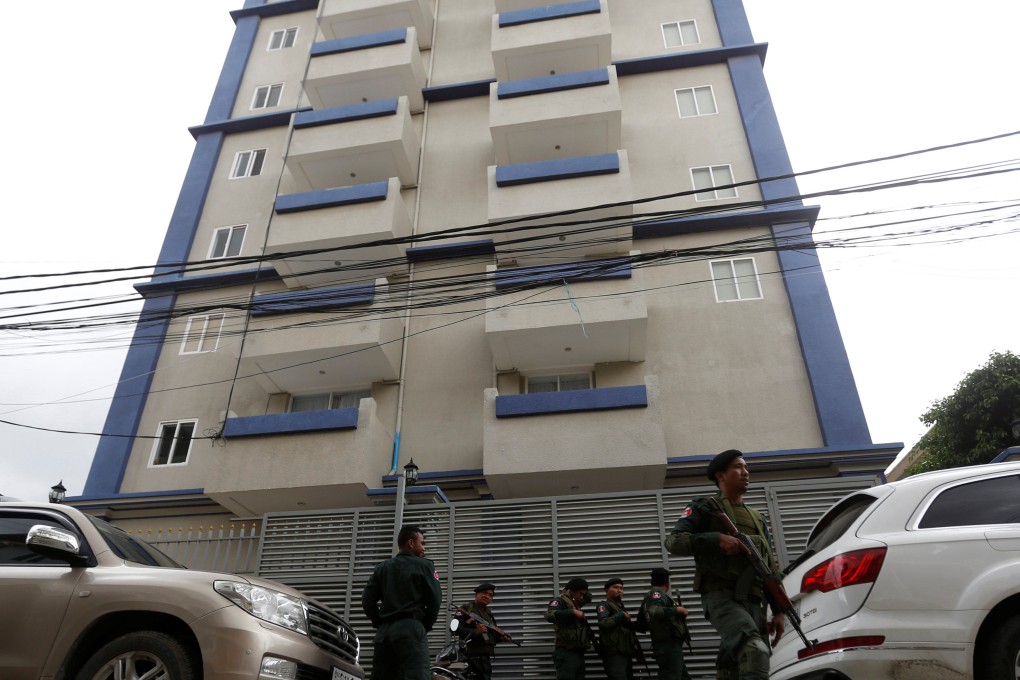 Cambodian police stand outside a Phnom Penh phone scam centre in 2017. Photo: Reuters