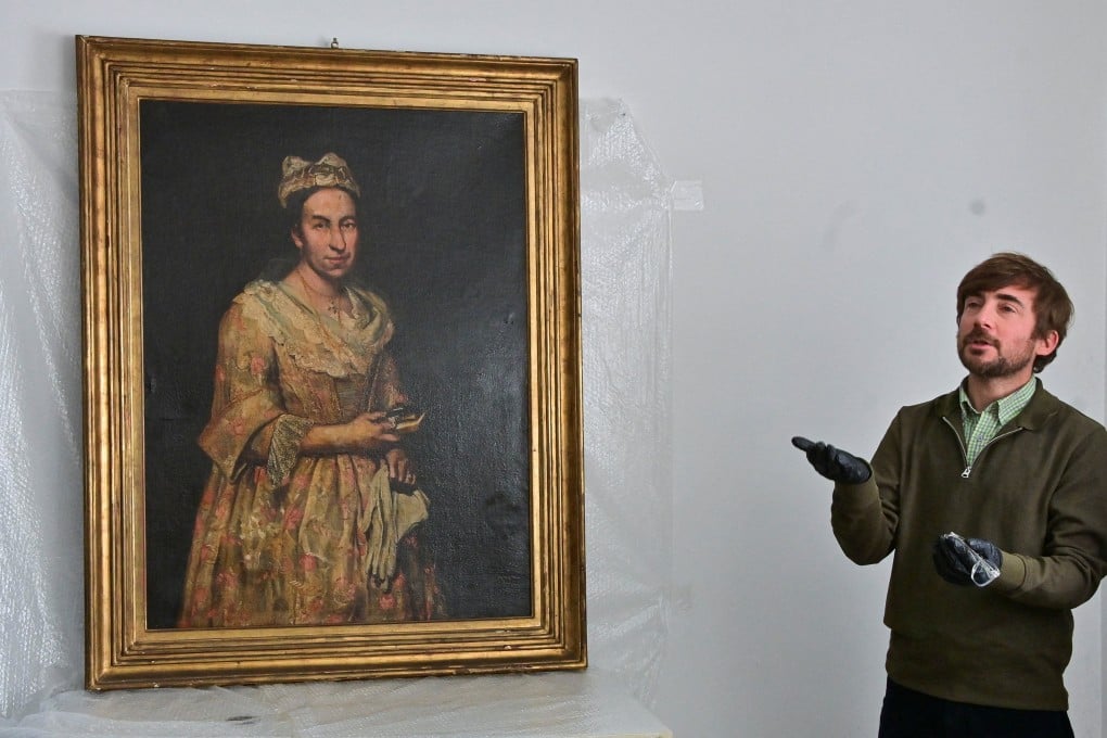 Curator Ariel Bassano stands next to Portrait of a Lady, a painting stolen decades ago by the Nazis, following its recovery by Argentine officials. Photo: Reuters