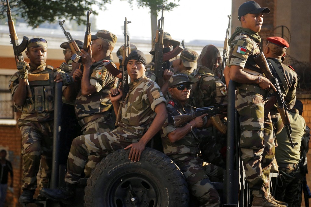 Members of the military outside the presidential palace after joining protesters in Antananarivo, Madagascar. Photo: Reuters