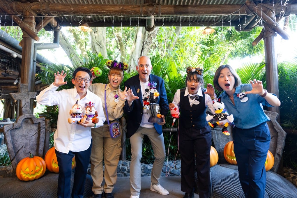 Tim Sypko (centre), Hong Kong Disneyland Resort’s senior vice-president of operations, showcases some of its Halloween merchandise alongside entertainment operations director Virginia Sung (far left), entertainment producer Laetitia Lee (far right) and frontline staff working in merchandise and food and beverage.