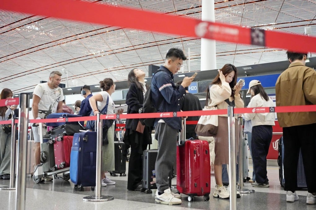 Passengers check in for a flight at Beijing Capital International Airport on October 1. Photo: Kyodo