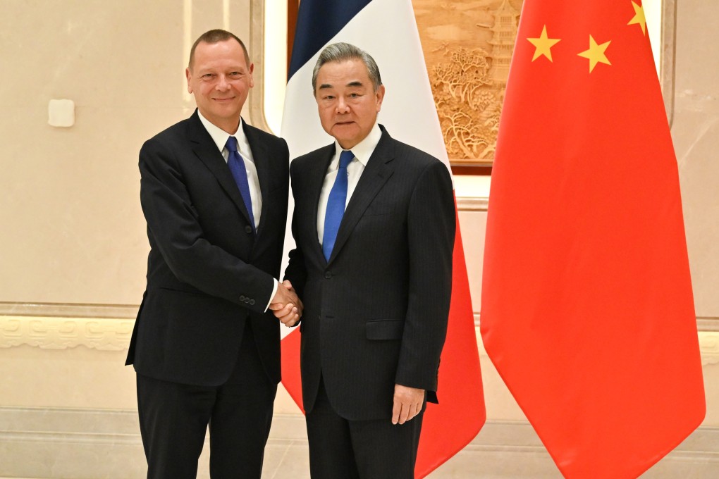 Chinese Foreign Minister Wang Yi with Emmanuel Bonne, diplomatic adviser to the French president, in Hangzhou on Wednesday. Photo: Xinhua