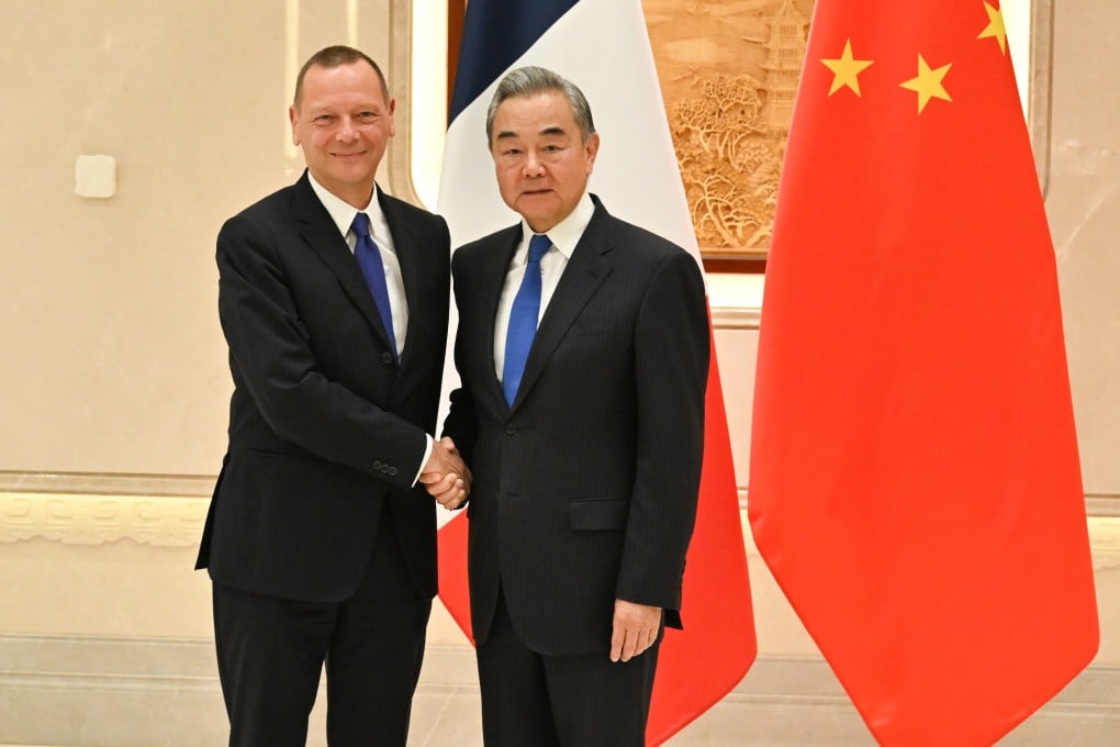 Chinese Foreign Minister Wang Yi with Emmanuel Bonne, diplomatic adviser to the French president, in Hangzhou on Wednesday. Photo: Xinhua