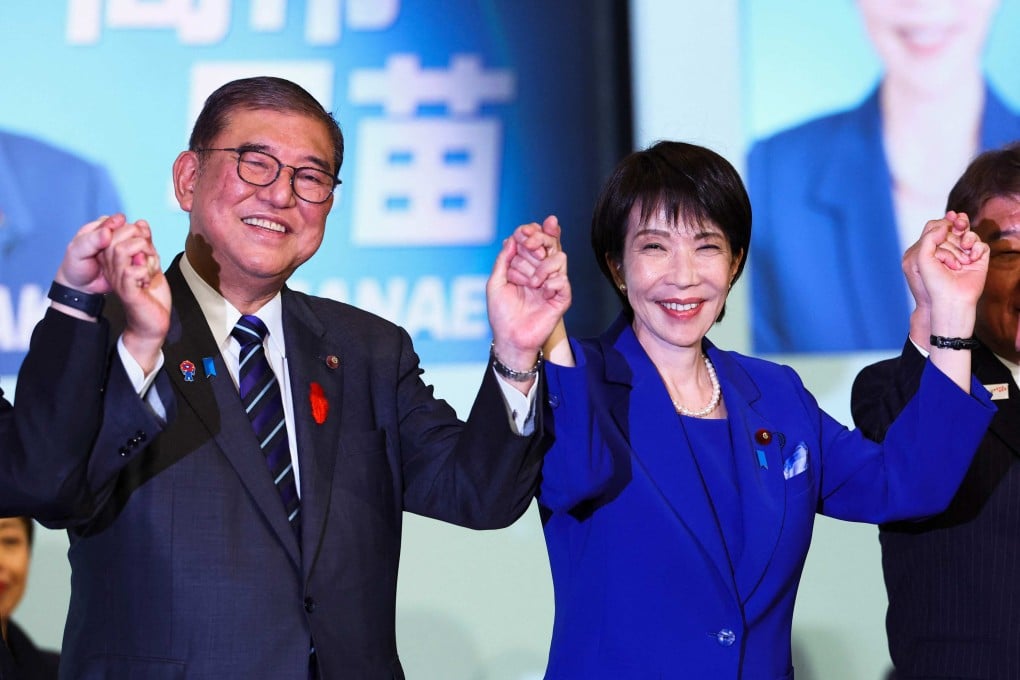 Newly elected leader of Japan’s Liberal Democratic Party (LDP) Sanae Takaichi, right, celebrates with Prime Minister Shigeru Ishiba after winning the LDP leadership election in Tokyo on October 4. Photo: AFP