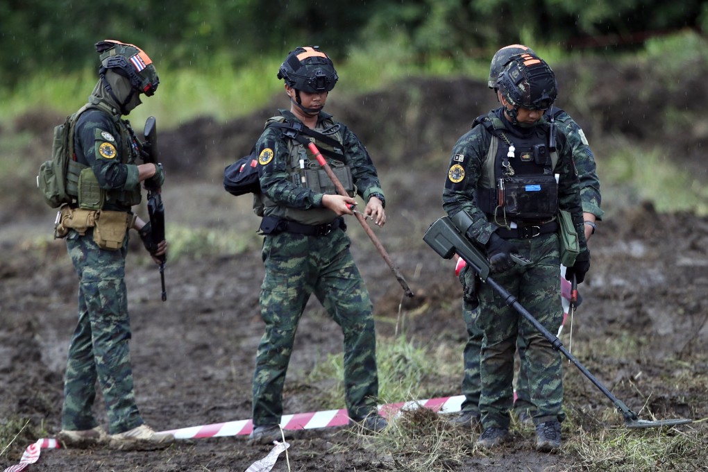 Thai soldiers conduct mine clearance operations in Sa Kaeo province near Thailand’s border with Cambodia on Friday. Photo: EPA