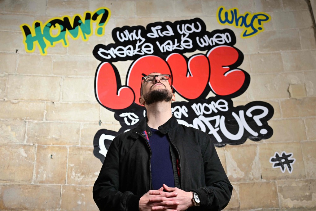 Poet Alex Vellis poses inside Canterbury Cathedral in Canterbury, southeast England, on October 16, 2025, where graffiti-style artworks are currently being displayed as part of an exhibition. Photo: AFP