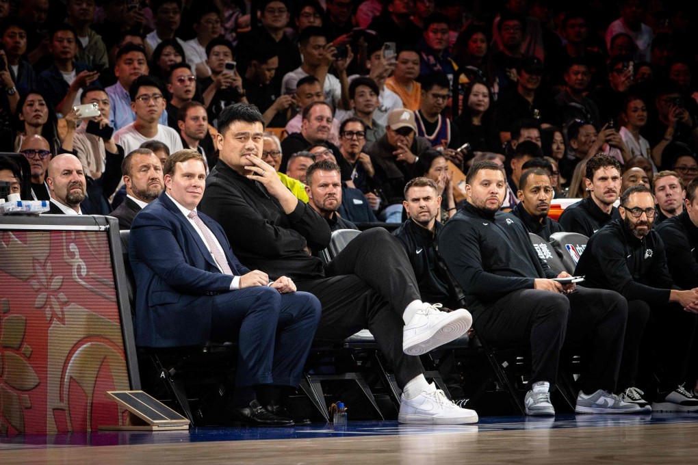 Former NBA player Yao Ming (second from left) and Patrick Dumont (left), CEO of Las Vegas Sands and owner of the Dallas Mavericks, follow the NBA pre-season game between the Phoenix Suns and the Brooklyn Nets at The Venetian Arena in Macau on October 12. Photo: AFP
