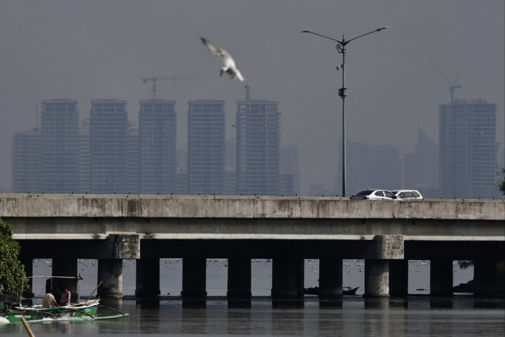 Dark clouds loom along Manila’s skyline, seen along the Bacoor City coastline, Cavite province, the Philippines, on Saturday. EPA
