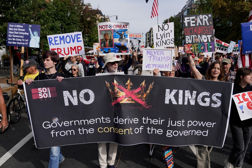 Demonstrators carry signs as they march to the national mall during a “No Kings” protest in Washington on Saturday. Photo: AP