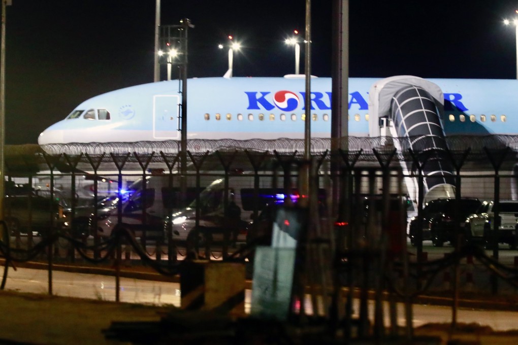 A Korean Air plane believed to be used for the suspects’ repatriation is seen at Techo International Airport near Phnom Penh, Cambodia, on Friday night. Photo: EPA