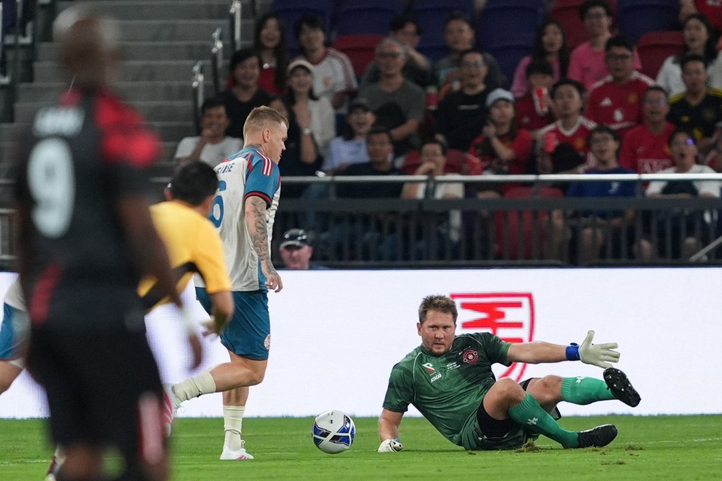 Goalkeeper Tomasz Kuszczak injured his knee as he fell and gave away an early goal to John Arne Riise (left). Photo: Eugene Lee