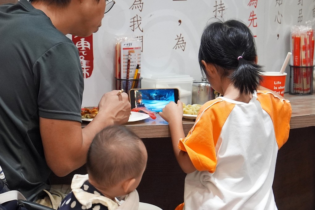 A child watches a video on a smartphone while eating at a restaurant. NGO Look Up Hong Kong is seeking to draw attention to the link between smartphone use and mental health. Photo: Elson Li