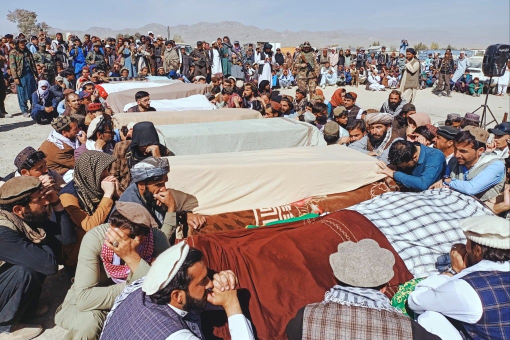 Residents pray over the bodies of victims of a Pakistani cross-border air strike during a funeral in the village of Khandaro in Afghanistan on Saturday. Photo: AP