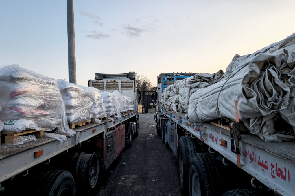 Trucks carrying humanitarian aid line up at the Egyptian side of the Rafah border crossing into Israel on Friday. Photo: Reuters