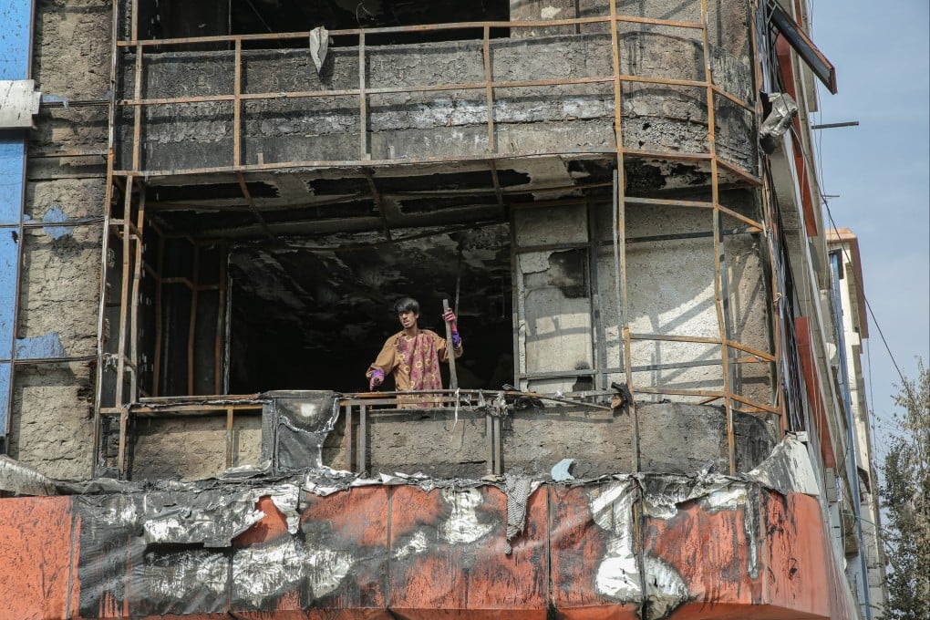 Men look out from a damaged building hit during an alleged Pakistani strike in Kabul, Afghanistan, on Sunday. Photo: EPA-EFE