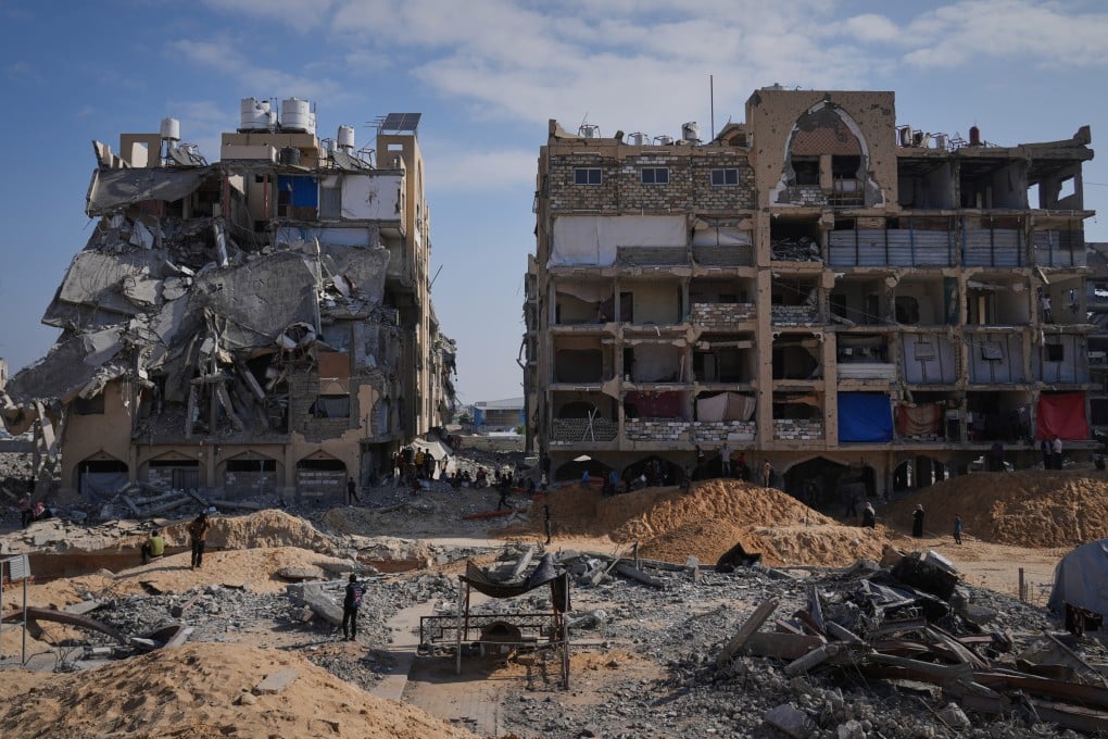 Members of Hamas search underground for the bodies of Israeli hostages amid destroyed buildings in Khan Younis, in the southern Gaza Strip, on Sunday. Photo: AP