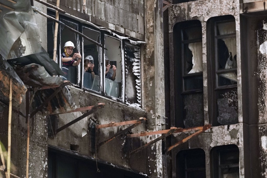 Government workers survey the damage caused by the fire. Photo: Karma Lo