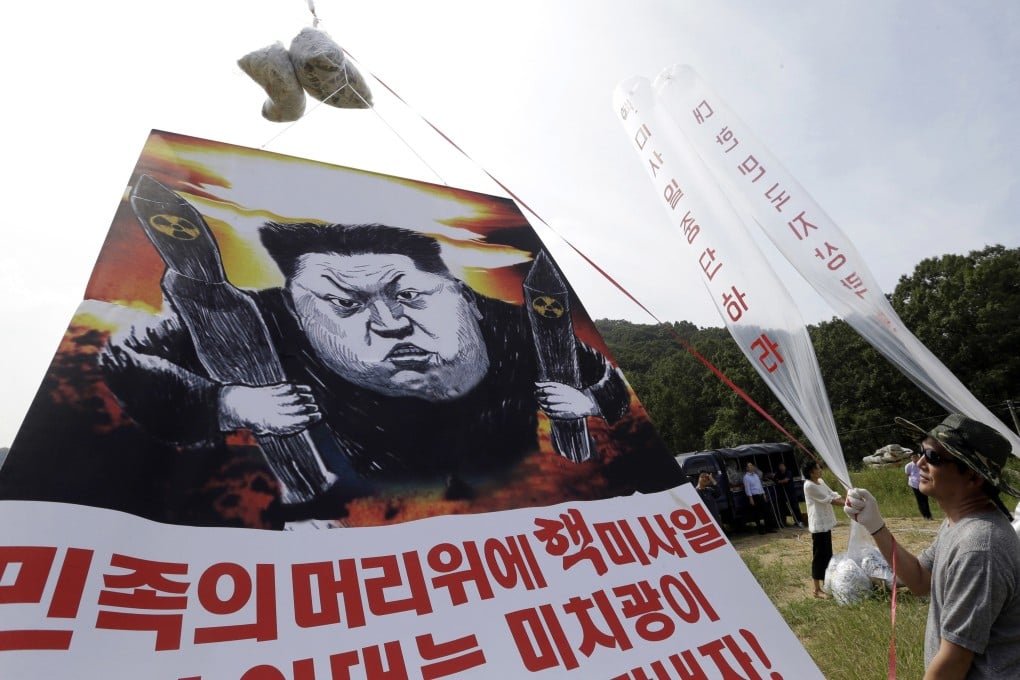 North Korean defectors in Paju, South Korea, prepare to release balloons carrying leaflets and a banner denouncing Kim Jong-un in 2016. Photo: AP