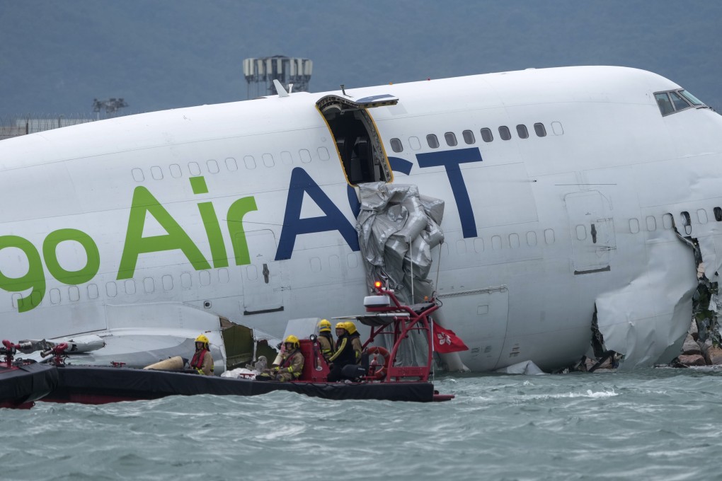 Two people were killed after the cargo plane skidded off the north runway of Hong Kong International Airport striking a ground vehicle and plunging almost entirely into the sea. Photo: Sam Tsang