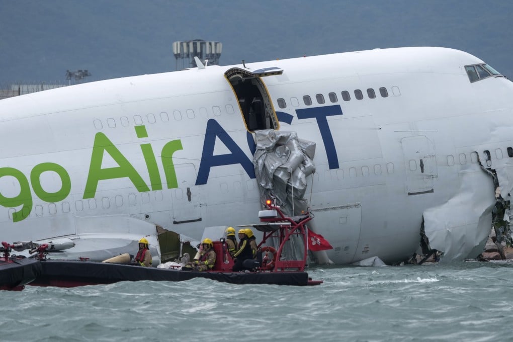 Two people were killed after the cargo plane skidded off the north runway of Hong Kong International Airport striking a ground vehicle and plunging almost entirely into the sea. Photo: Sam Tsang