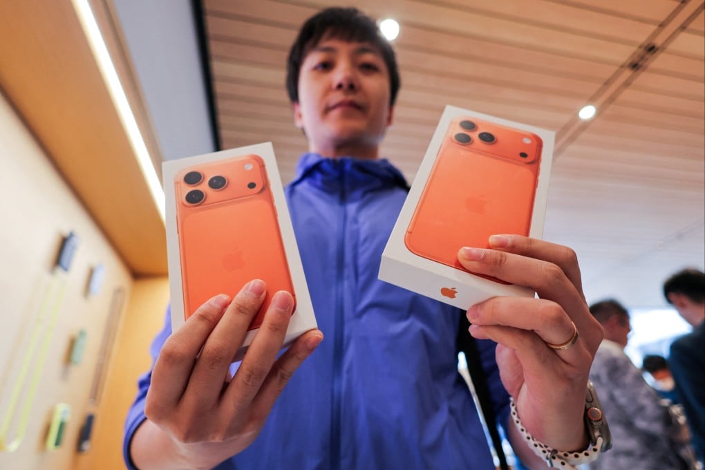 A man shows boxes with newly bought iPhone 17 handsets inside the Apple Store in Beijing’s Sanlitun area. Photo: Reuters