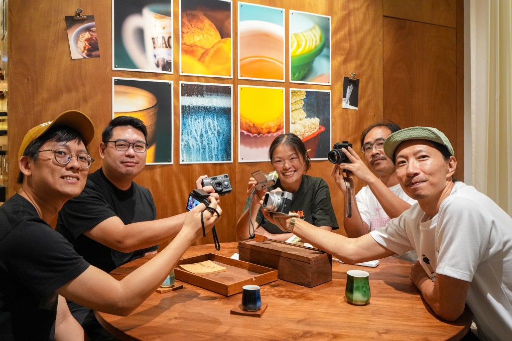 (From left) Jeremy Cheung, Enoch Ho,
Maoshan Connie, Hong and Chan Kit pose for a group photo on the opening day of an exhibition about cha chaan tengs in the K11 Art Mall in Tsim Sha Tsui. Photo: Eugene Lee